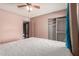 Bedroom with a view to a closet, large window, and tan walls with a white bed at 1123 W Mendoza Ave, Mesa, AZ 85210