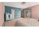 Comfortable bedroom with tile flooring, soft lighting, and access to the outside at 1123 W Mendoza Ave, Mesa, AZ 85210