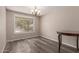 Inviting dining room with wood floors, a chandelier, and large windows at 1123 W Mendoza Ave, Mesa, AZ 85210