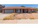 Charming single-story brick home featuring a bay window, attached garage, and well-lit entry way at 1123 W Mendoza Ave, Mesa, AZ 85210