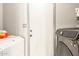 Laundry area equipped with a washer and dryer; adjacent is a door at 1123 W Mendoza Ave, Mesa, AZ 85210