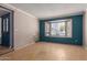 Spacious living room with hardwood floors, a bay window, and neutral wall colors at 1123 W Mendoza Ave, Mesa, AZ 85210