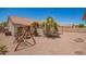 Backyard with a play structure, desert landscaping, and ample space for Gathering activities at 11352 E Dartmouth St, Mesa, AZ 85207