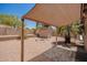 Inviting backyard with a shade structure, convenient shed, and low-maintenance desert landscaping at 11352 E Dartmouth St, Mesa, AZ 85207