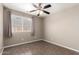 Bedroom with a ceiling fan and window, offering a bright and airy atmosphere at 11352 E Dartmouth St, Mesa, AZ 85207