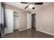 Bedroom featuring closet, doorway, window and ceiling fan at 11352 E Dartmouth St, Mesa, AZ 85207