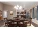 Open-concept dining area with a stylish table setting, seamlessly flowing into the kitchen for easy entertaining at 11352 E Dartmouth St, Mesa, AZ 85207