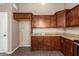 Bright kitchen featuring wooden cabinetry, granite countertops, and tile floors at 11352 E Dartmouth St, Mesa, AZ 85207