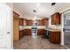 Bright kitchen featuring wood cabinets, granite counters, stainless steel appliances, and tile flooring at 11352 E Dartmouth St, Mesa, AZ 85207
