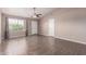 Living room features a ceiling fan, neutral paint, tile flooring, and a large window at 11352 E Dartmouth St, Mesa, AZ 85207