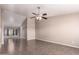 Spacious living room featuring high vaulted ceilings, ceiling fan, tile flooring, and neutral paint at 11352 E Dartmouth St, Mesa, AZ 85207