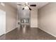 Open living room with tile floors, a ceiling fan, and views into the dining and kitchen areas at 11352 E Dartmouth St, Mesa, AZ 85207
