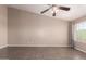 Well-lit living room features a ceiling fan, vaulted ceilings, and tile flooring at 11352 E Dartmouth St, Mesa, AZ 85207