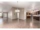 Open concept living space with tile floors, chandelier, ceiling fans, and kitchen with granite counter tops at 11352 E Dartmouth St, Mesa, AZ 85207