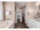 Main bathroom featuring dual sinks, tile floors, and a separate shower and tub, a spa-like experience at 11352 E Dartmouth St, Mesa, AZ 85207
