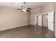 Well-lit main bedroom with tile flooring and ceiling fan, offering ample space for customization at 11352 E Dartmouth St, Mesa, AZ 85207