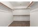 A spacious walk-in closet offering ample storage with multiple shelves and hanging rods at 11352 E Dartmouth St, Mesa, AZ 85207