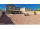 Large backyard showcases a covered patio, outdoor dining area, and easy-care desert landscaping at 12325 W Dreyfus Dr, El Mirage, AZ 85335