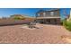 Expansive backyard with a covered patio, outdoor seating, and low-maintenance gravel landscaping at 12325 W Dreyfus Dr, El Mirage, AZ 85335