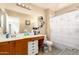 Bathroom featuring double vanity, tile flooring, and a shower with curtain at 12325 W Dreyfus Dr, El Mirage, AZ 85335