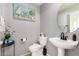 Elegant half-bath features a pedestal sink, decor, and soothing paint color at 12325 W Dreyfus Dr, El Mirage, AZ 85335