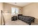 Cozy bedroom with neutral walls, window, and carpet at 12325 W Dreyfus Dr, El Mirage, AZ 85335