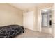 Cozy bedroom featuring neutral walls, closet with sliding doors, and carpet flooring at 12325 W Dreyfus Dr, El Mirage, AZ 85335