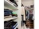 Walk-in closet with shelving and organized clothing at 12325 W Dreyfus Dr, El Mirage, AZ 85335