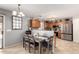 Charming dining area with modern table and chairs, flowing into a kitchen with wood cabinetry at 12325 W Dreyfus Dr, El Mirage, AZ 85335
