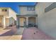 Charming covered front porch with seating area, neutral tones, desert landscaping, and mature landscaping at 12325 W Dreyfus Dr, El Mirage, AZ 85335