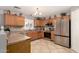 Well-lit kitchen with wood cabinets, stainless steel appliances, and neutral countertops at 12325 W Dreyfus Dr, El Mirage, AZ 85335