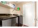 Functional laundry room featuring modern washer and dryer, storage shelves, and convenient access at 12325 W Dreyfus Dr, El Mirage, AZ 85335