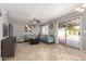 Bright living room with stylish seating, tile floors, neutral walls, access to backyard, and ceiling fan at 12325 W Dreyfus Dr, El Mirage, AZ 85335
