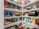 Spacious, organized pantry featuring shelving filled with a variety of food and household items at 12325 W Dreyfus Dr, El Mirage, AZ 85335