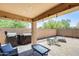 Covered patio features string lights, a barbecue, and a table and chairs in the backyard at 1397 E Laurel Pl, Casa Grande, AZ 85122