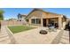 Private backyard with a covered patio, green turf, and a paver patio perfect for outdoor entertaining at 1397 E Laurel Pl, Casa Grande, AZ 85122