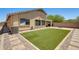 Fully fenced backyard features artificial grass, stone pavers, barbecue area and space to entertain at 1397 E Laurel Pl, Casa Grande, AZ 85122