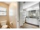 Well-lit bathroom showcasing a dual sink vanity and framed mirror with a separate toilet room at 1397 E Laurel Pl, Casa Grande, AZ 85122
