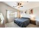 Cozy bedroom with neutral color scheme, large window, and ceiling fan at 1397 E Laurel Pl, Casa Grande, AZ 85122