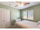 Well-lit bedroom showcasing a ceiling fan, a window, and a closet for storage at 1397 E Laurel Pl, Casa Grande, AZ 85122