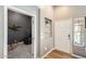 Inviting entryway with white front door, convenient shelf space, and gray accent walls at 1397 E Laurel Pl, Casa Grande, AZ 85122