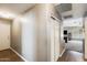 Bright hallway featuring wood floors and a linen closet leading into the living area at 1397 E Laurel Pl, Casa Grande, AZ 85122