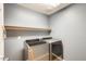 This laundry room features a gray washer and dryer, with a shelf above for extra storage at 1397 E Laurel Pl, Casa Grande, AZ 85122