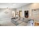 Spacious living room featuring a large gray sectional and open floor plan at 1397 E Laurel Pl, Casa Grande, AZ 85122