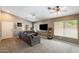 Bright living room with sectional couch, and large windows allowing for plenty of natural light at 1397 E Laurel Pl, Casa Grande, AZ 85122