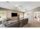 Comfortable living room with plush gray sectional sofa, ceiling fan, and natural light at 1397 E Laurel Pl, Casa Grande, AZ 85122