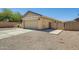 Exterior view of a home with a two-car garage, driveway, and fenced area at 1397 E Laurel Pl, Casa Grande, AZ 85122