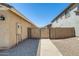 View of a side yard with a secure gate and well-maintained gravel landscaping at 1397 E Laurel Pl, Casa Grande, AZ 85122
