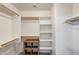 Spacious walk-in closet featuring custom shelving and wooden rods for ample storage at 1397 E Laurel Pl, Casa Grande, AZ 85122