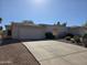 A single story home featuring a stucco exterior, a two car garage, and a large concrete driveway at 14214 N Galatea Dr # A, Fountain Hills, AZ 85268